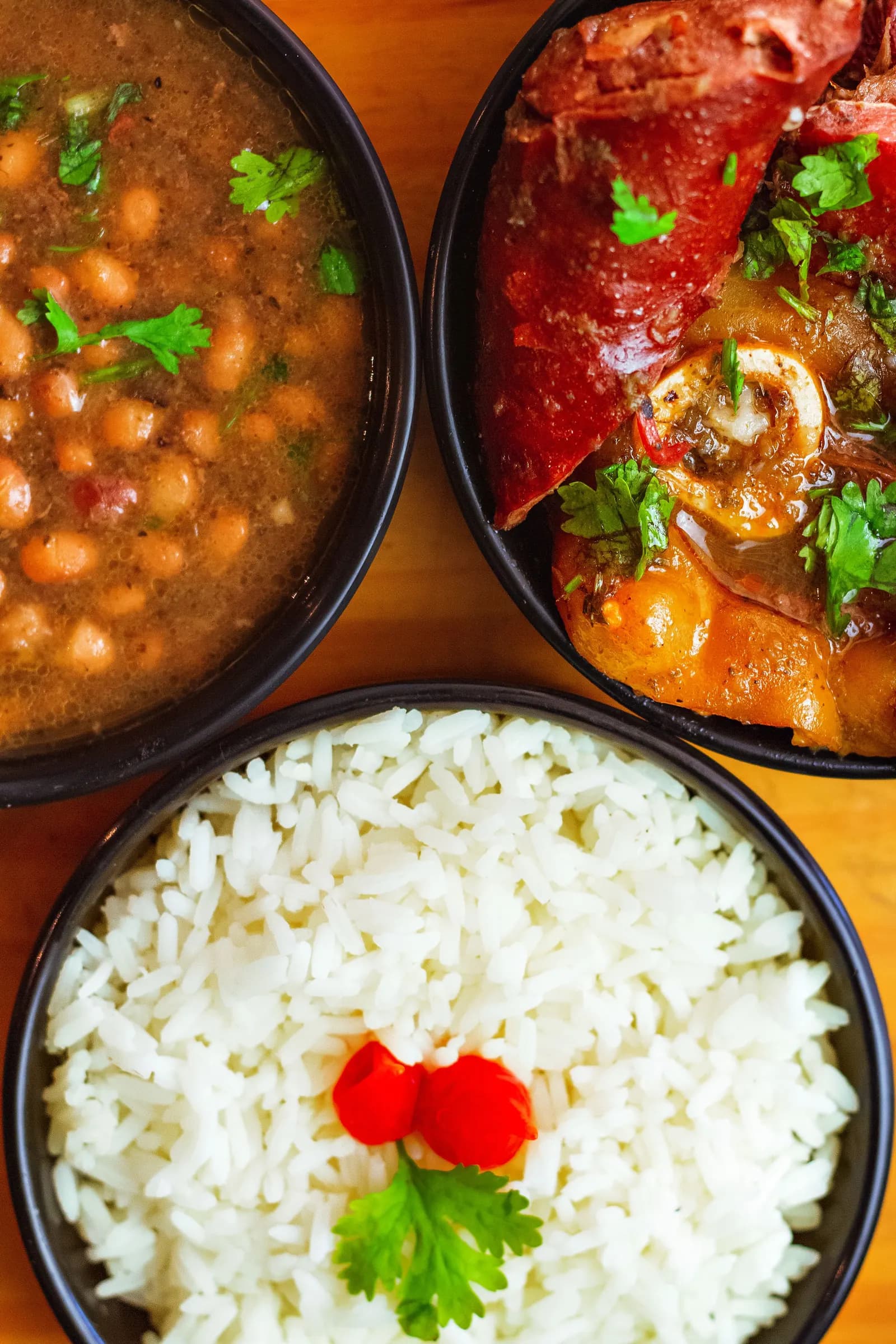 Chole and steamed rice in dark bowls